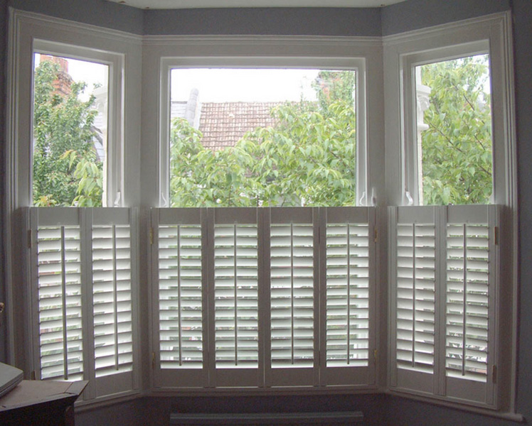 The image shows a room with white shuttered windows, allowing natural light to enter and illuminate the space.