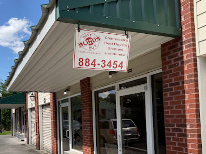 The image shows a storefront with a sign advertising 'Blinds, Shutters & Blind Repair' and contact information.