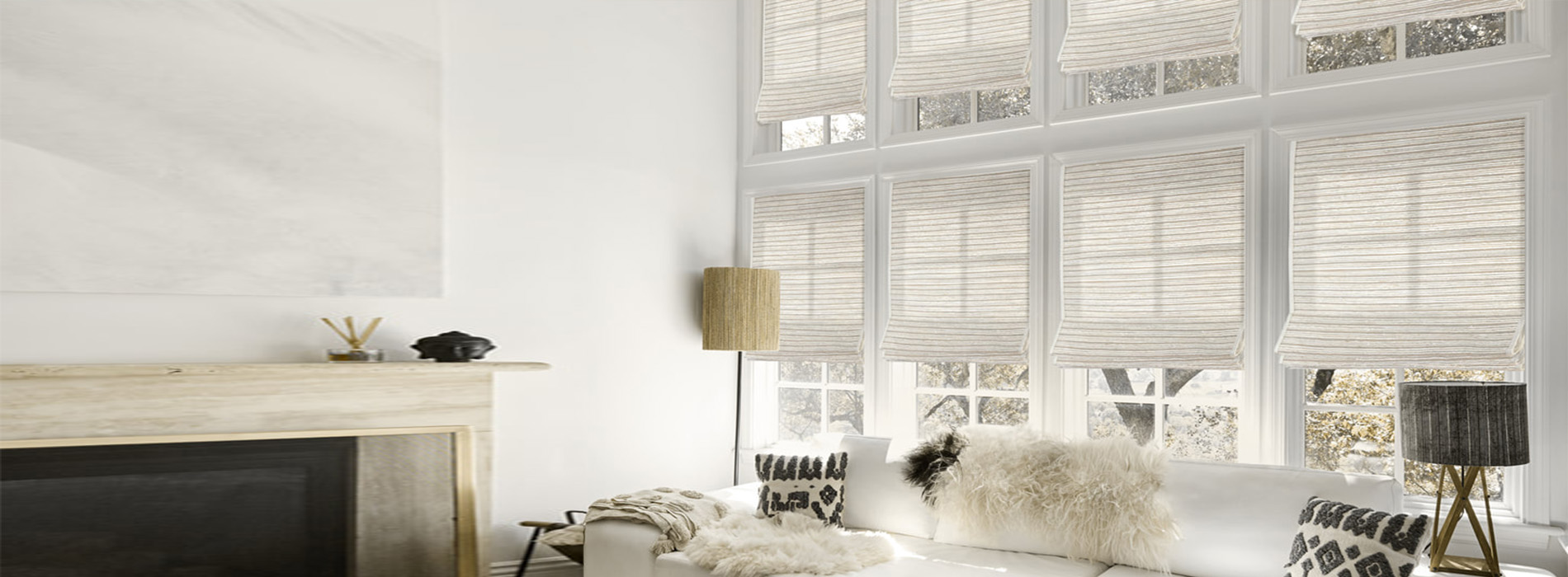 A modern living room with a large window, white walls, and a neutral color palette.